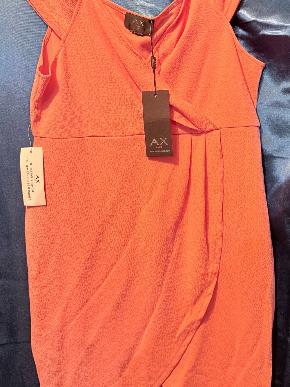 Peach colored off the shoulder dress.